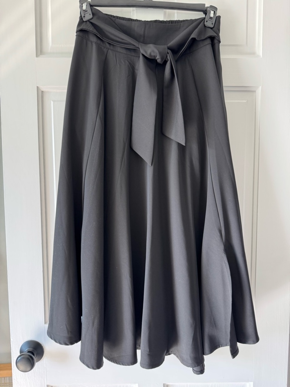 Belle Poque high-waisted A-line skirt with a flared hem, decorative waist tie.